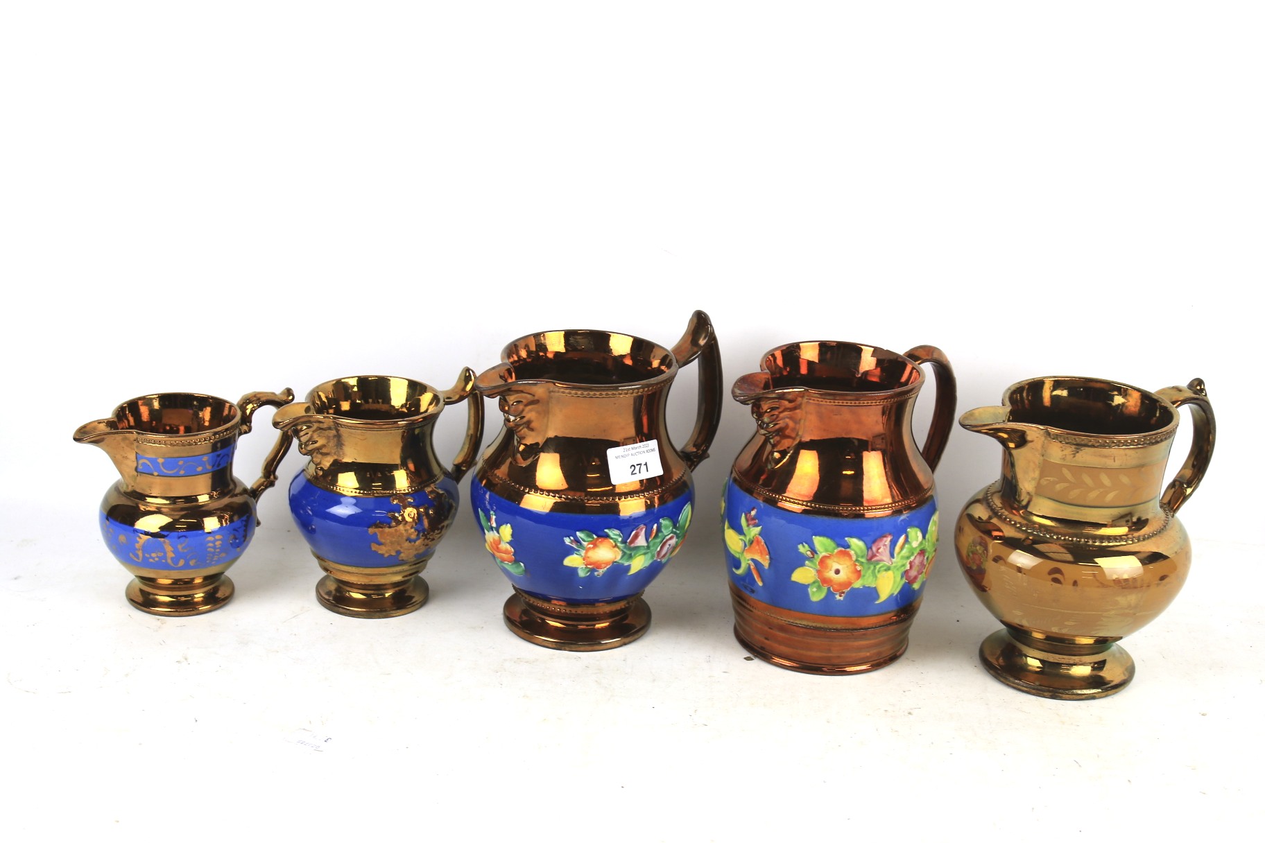 Four copper jugs. Four graduation jugs and one other, largest H18cm.