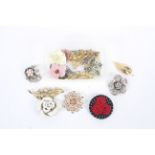 A small group of modern and vintage brooches in the shape of flowers