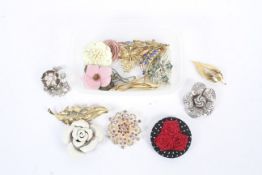 A small group of modern and vintage brooches in the shape of flowers