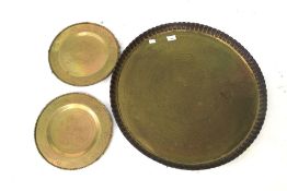Three vintage Indian brass engraved chargers. Largest with pressed rim, D62cm.