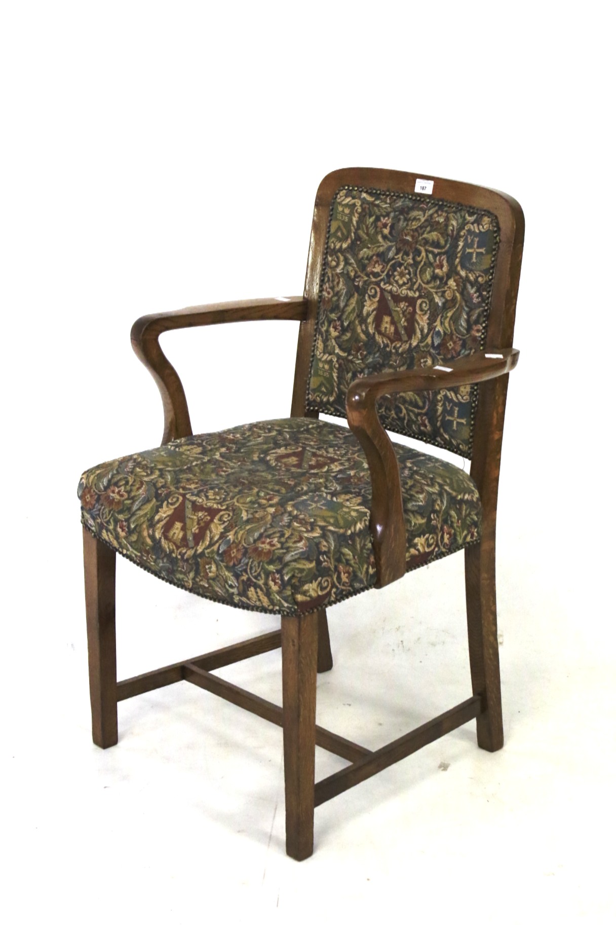 A 20th century oak framed open elbow upholstered chair.