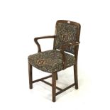 A 20th century oak framed open elbow upholstered chair.