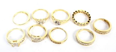 Nine silver gilt dress rings all set with zircon stones, various sizes.