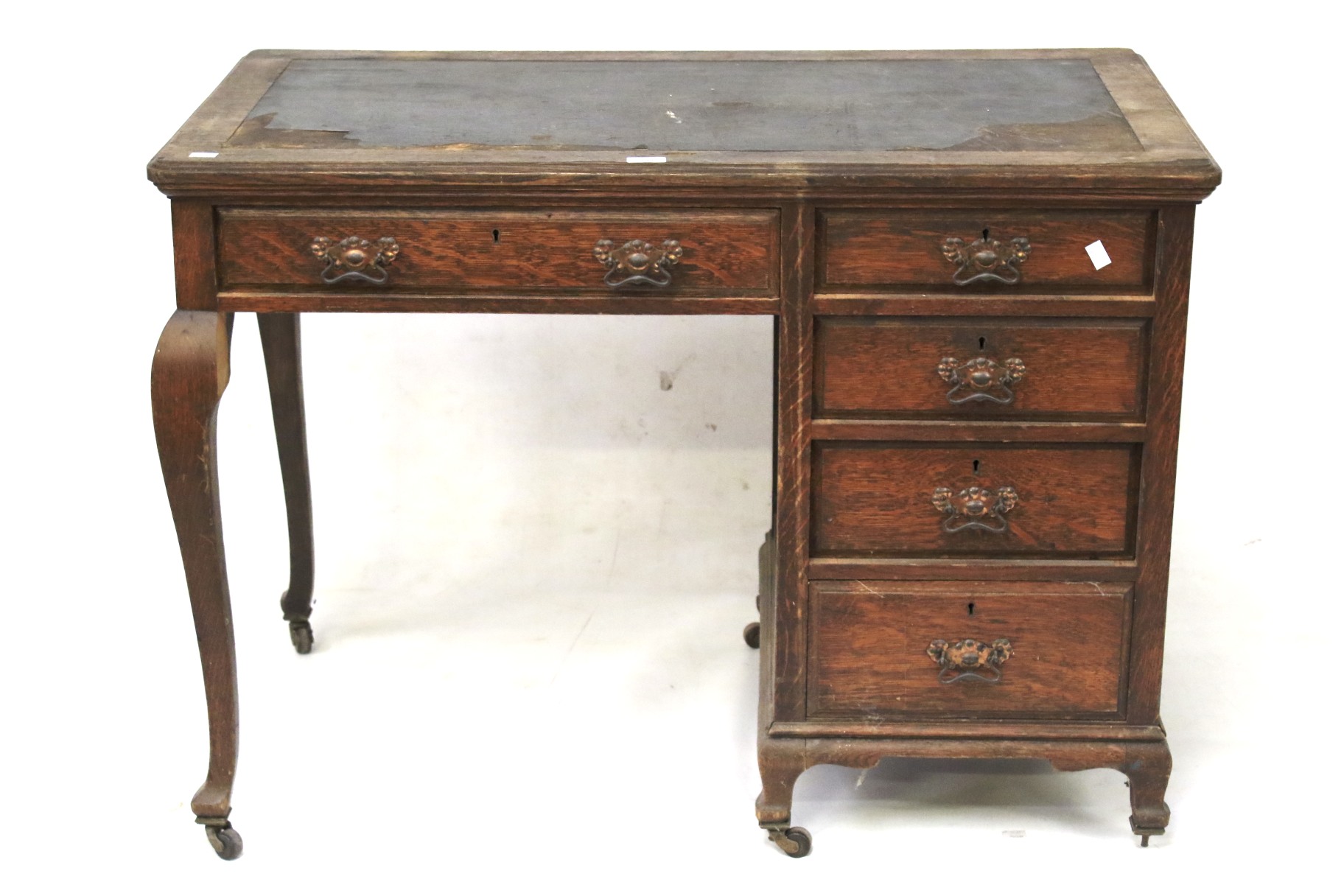 An oak desk complete with 5 drawers, on wheels. H76cm x W105cm x D60cm.