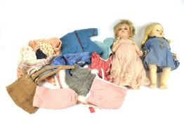 Two 1950s hard plastic dolls and a quantity of clothing.