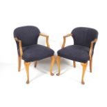 A pair of early to mid-20th century upholstered armchairs.