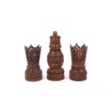 A 19th century carved coquilla nut pounce pot or shaker and two similar stands.