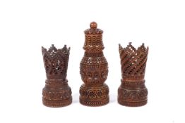 A 19th century carved coquilla nut pounce pot or shaker and two similar stands.