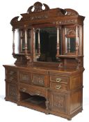 A large Edwarian oak sideboard of canted rectangular form.
