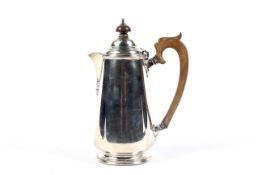 A silver coffee pot in George III style.
