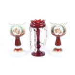 A pair of late 19th/early 20th century opaque glass lustres and a single ruby glass lustre.