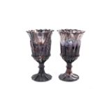 A pair of late 19th century pressed glass vases in marbled amethyst tint.