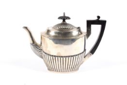 A silver small oval part fluted teapot.