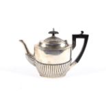 A silver small oval part fluted teapot.