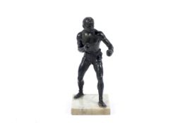 A bronze figure of a boxer in fighting pose.