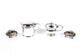 A pair of late Victorian silver shell-shaped open salts and spoons and two mustard pots.