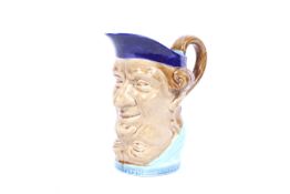 A late 19th century Sarreguemines majolica double mask toby jug. Impressed marks, shape no.