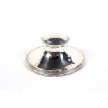 A silver capstan shaped ink well.