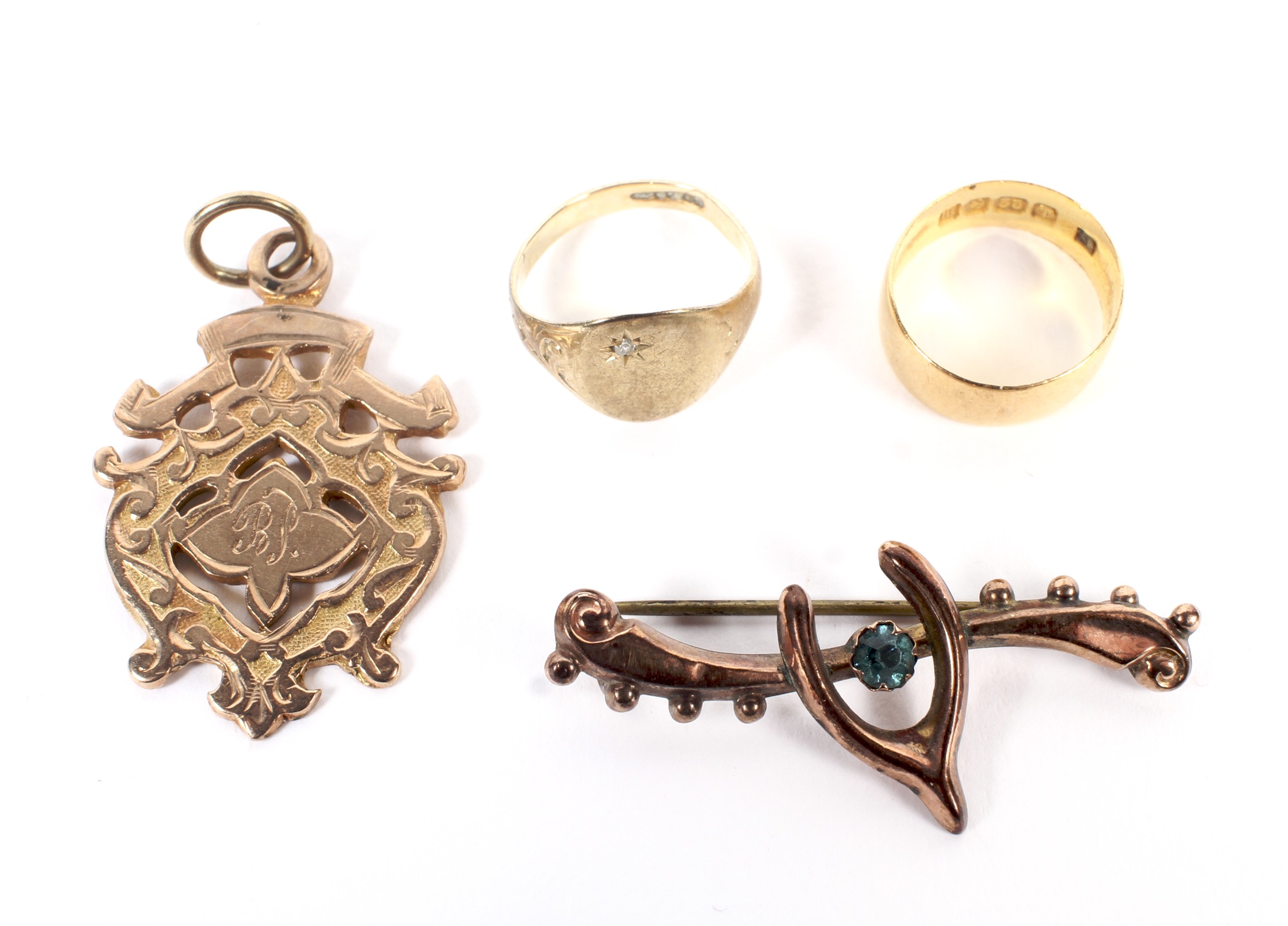 Two child's gold rings, a fob medallion and a brooch.