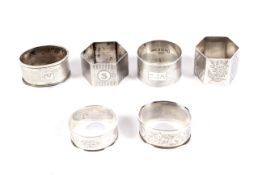 Six assorted silver napkin rings.