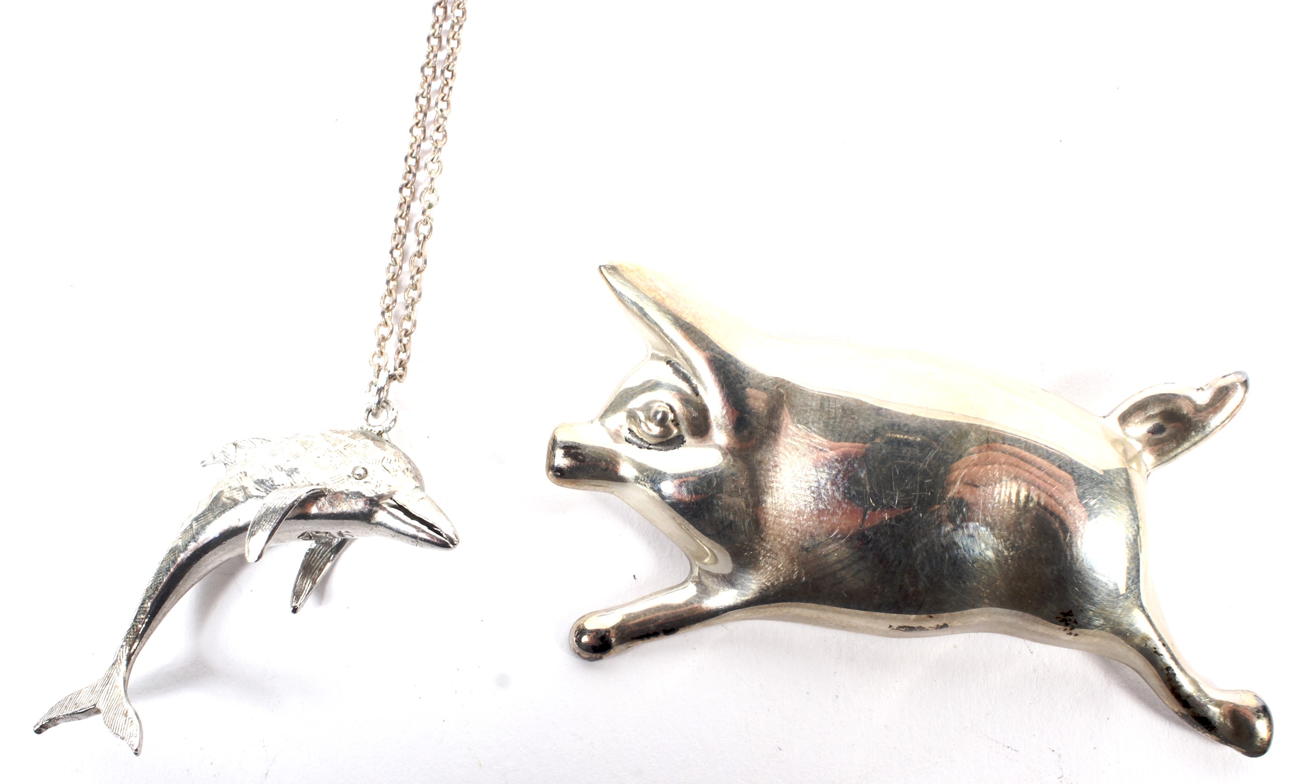 A vintage silver dolphin pendant and a Mexican brooch in the form of a pig. - Image 2 of 2