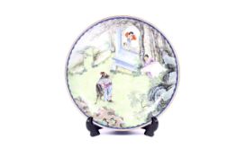 A Chinese porcelain famille rose enamelled circular shallow dish.