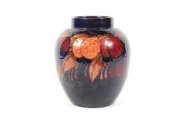 An early 20th century Moorcroft Plum pattern blue-ground ginger jar.