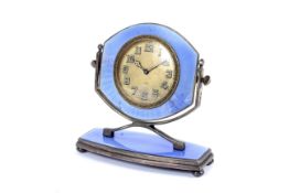 An Art Deco 8-day desk top silver and enamel mounted clock.