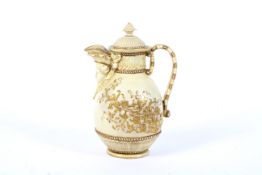A late 19th century Royal Worcester ivory ground mask-spouted coffee pot and cover.