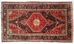 A Persian Hamadan rug.