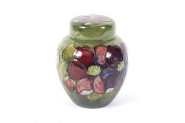 A Moorcroft green ground ginger jar and cover in the Clematis pattern.