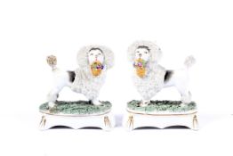 A pair of Continental porcelain Staffordshire style models of poodles, early 20th century.