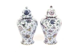 A pair of Thomas Till & Sons Pekin pattern pottery vases and domed covers, circa 1900.