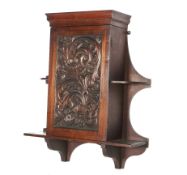 A Victorian carved mahogany hanging wall cupboard.