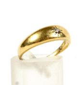 An early 20th century gold and diamond solitaire gypsy ring.