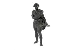A 19th century bronze figure of a chained and scantily draped mythological figure.