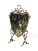 An early 20th century brass heart-shaped mirrored fire screen.