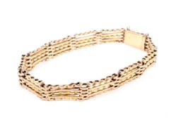 An early 20th century rose gold part-textured five-bar gate bracelet.