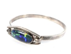 A vintage silver and black-opal-doublet single stone bangle.