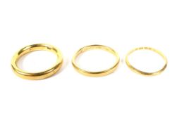 Three Victorian and later 22ct gold wedding bands. Comprising: a court shaped band, 3.