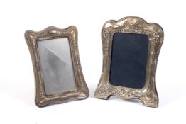 Two silver easel photo frames.