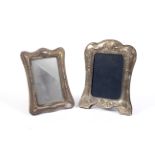 Two silver easel photo frames.