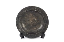 An antique pewter plate.
