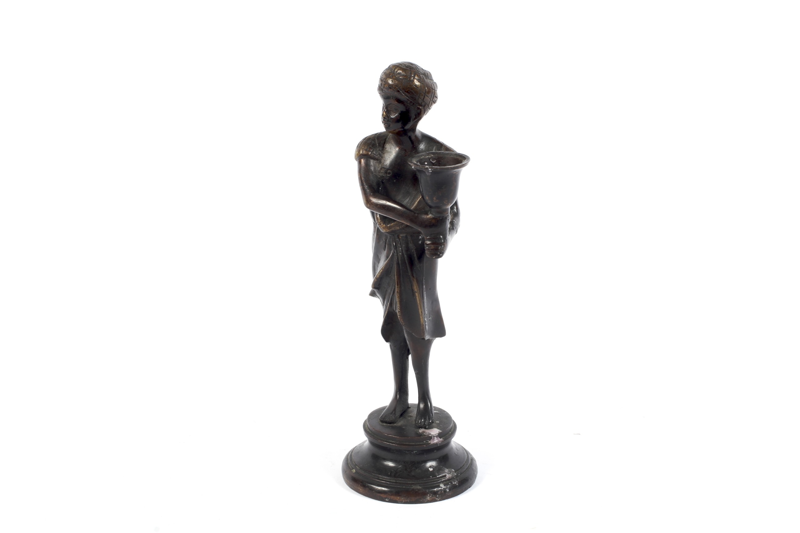 A bronze figural candlestick.