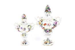 Two Sitzendorf porcelain flower-encrusted pot-pourri vases and pierced covers, circa 1900,