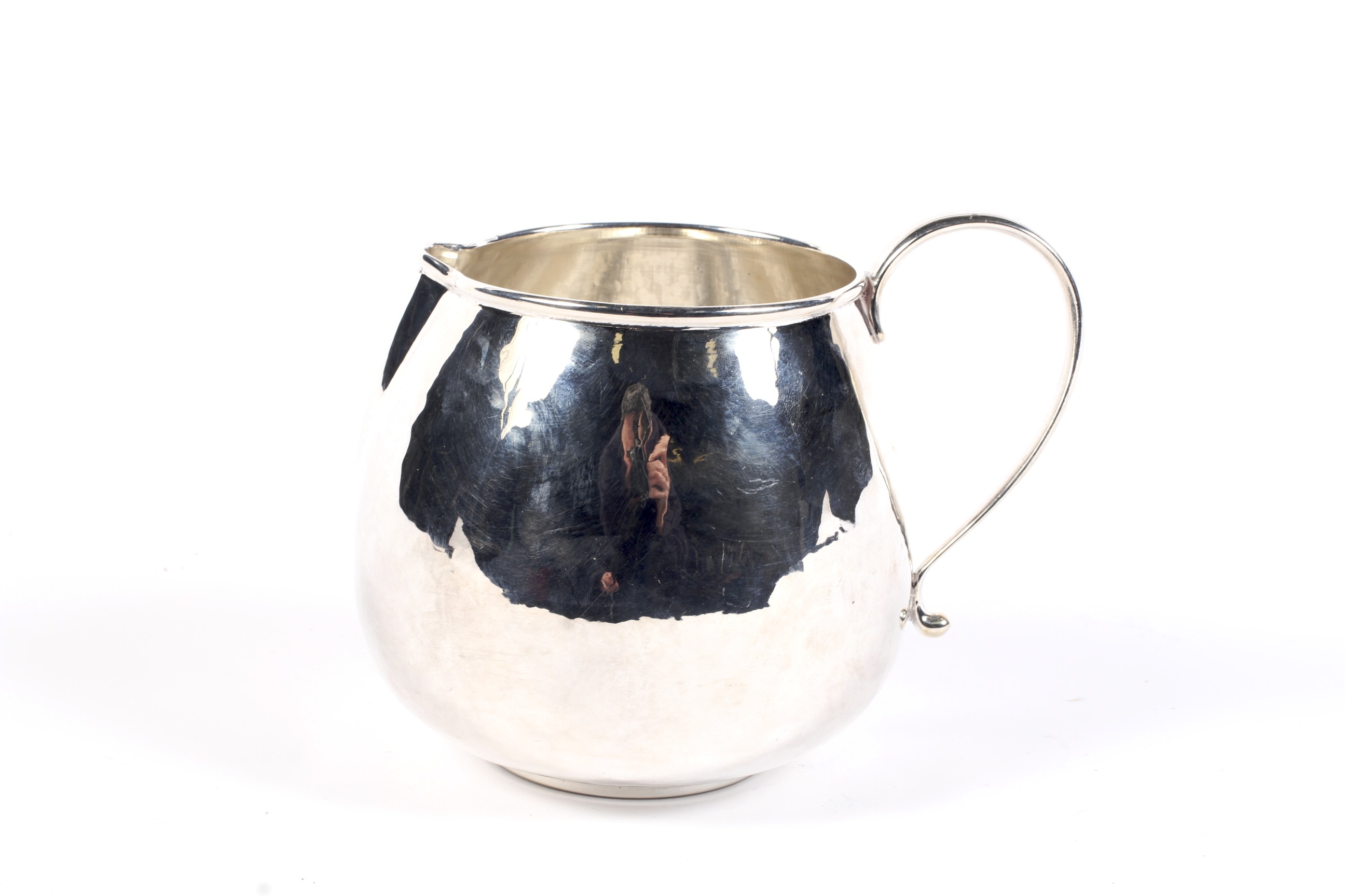 An Italian white metal bulbous round milk jug by Braganti.