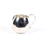 An Italian white metal bulbous round milk jug by Braganti.