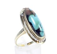 A Continental gold, turquoise and seed pearl oval cluster ring.