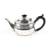 A silver small oval teapot.