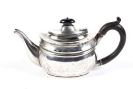 A silver small oval teapot.